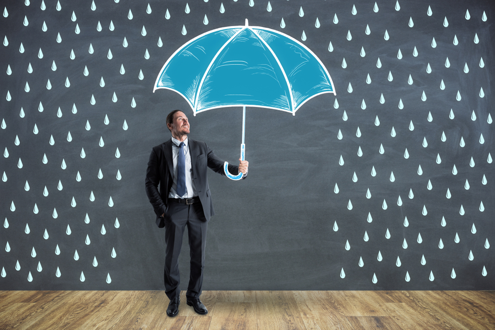 businessman using an umbrella. security concept