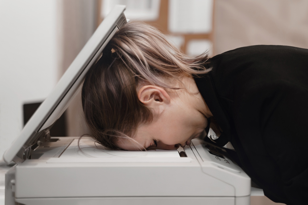 Businesswoman frustrated with printer. Printing problems concept.