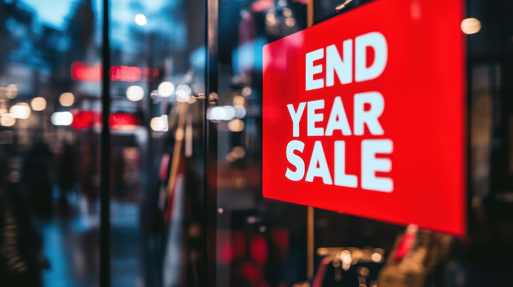 A close-up of a shop window displaying "END YEAR SALE". Concept of office equipment year end sale.