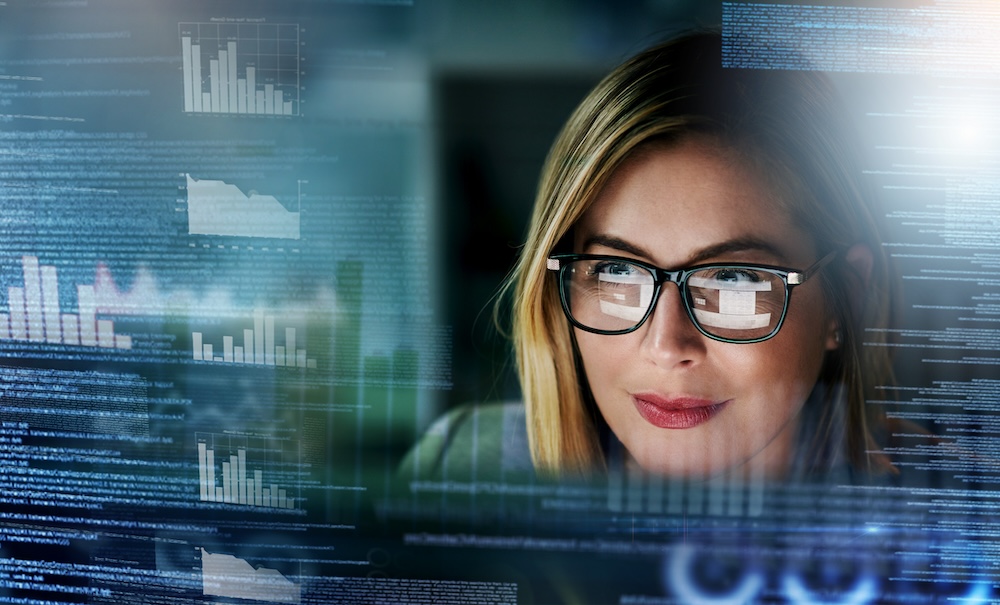 Shot of a young businesswoman working on a computer, analyzing technology metrics.