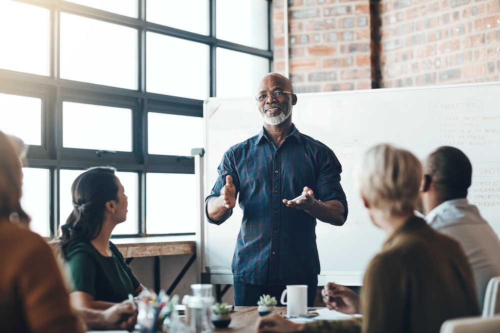 Business man talking in a training workshop in a boardroom. 